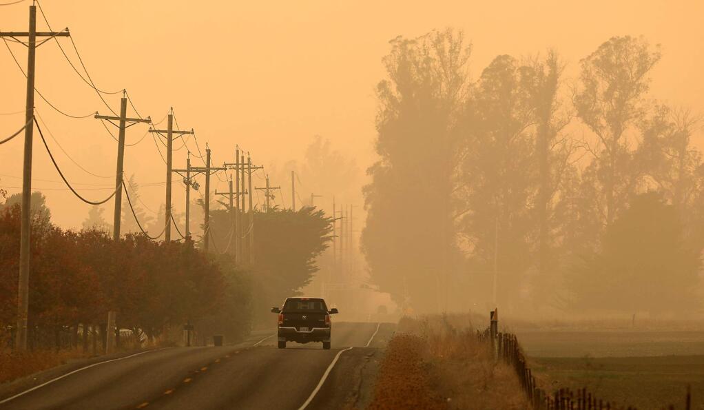 A sickly smoky haze settles over East Railroad Ave., near Rohnert Park, Friday afternoon Nov. 16, 2018 a by product of the Camp fire in Butte County. (Kent Porter / The Press Democrat) 2018