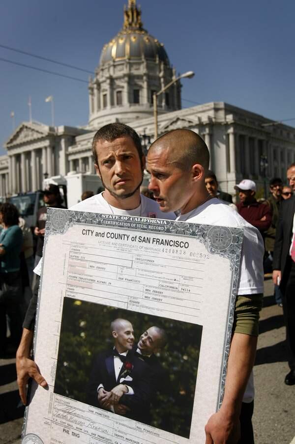 Joe, left, and Frank Capley-Alfano of Guerneville react in dismay as they heard the California Supreme Court upheld the constitutionality of Proposition 8 on Tuesday morning. The two were married in 2008 and enlarged their marriage license for the rally in front of the Earl Warren building in San Francisco.