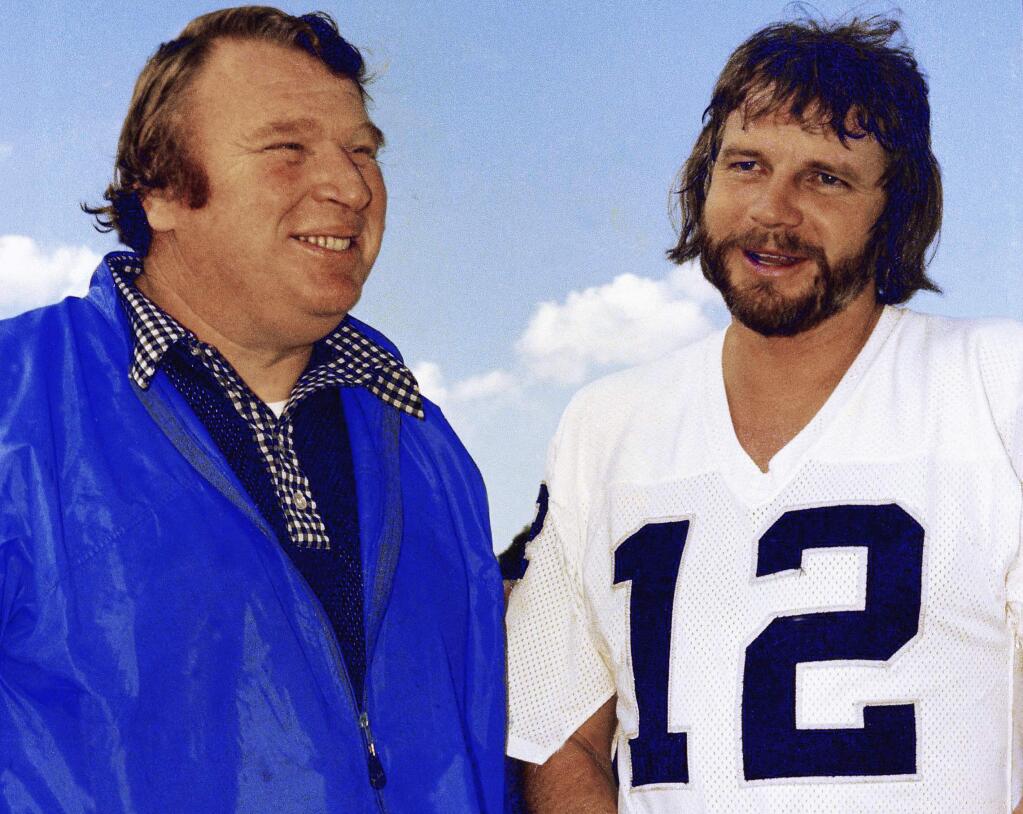 In this Jan. 4, 1977, file photo, Oakland Raiders quarterback Ken Stabler, right, talks with coach John Madden in Oakland, Calif. Stabler, who led the Raiders to a Super Bowl victory and was the NFL's Most Valuable Player in 1974, has died as a result of complications from colon cancer. He was 69. His family announced his death on Stabler's Facebook page on Thursday, July 9, 2015. (AP Photo/George Brich, File)