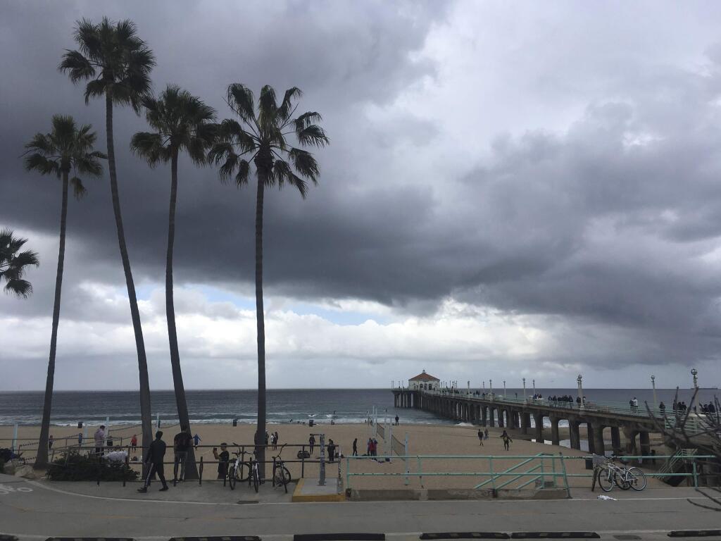Storm clouds gather over Santa Monica Bay off Manhattan Beach, Calif., Sunday, Feb. 9, 2020. A gust of 209 mph was recorded by an instrument on Kirkwood Mountain south of Lake Tahoe. The National Weather Service it could take months for state climatologists to verify the record. The previous record was a gust of 199 mph at Ward Mountain west of Lake Tahoe in 2017. (AP Photo/John Antczak)
