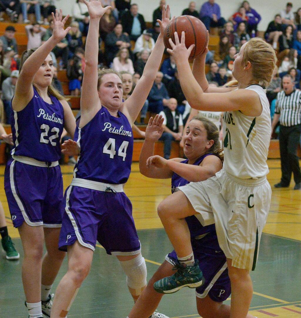 SUMNER FOWLER/FOR THE ARGUS-COURIERCasa Grande's Trinity Merwin gets a shot up over the determined guard of Petaluma's Mallory O'Keefe, Rose Nevin (44) and Bella Weinberg (22).