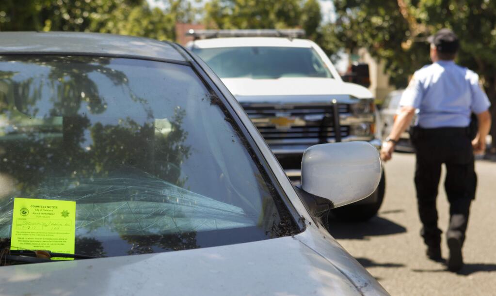 Tim Harmon, a vehicle abatement officer for the Petaluma Police Department, acts in 2017 on caller complaints about abandoned vehicles and then follows up to see if they have been removed before issuing citations and calling for a tow truck. Cars cannot be left parked on city streets for more than 72 hours. (Crissy Pascual /Argus-Courier staff)