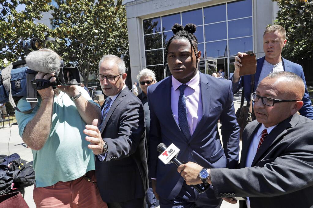 San Francisco 49ers linebacker Reuben Foster, center, leaves the Santa Clara County Superior Court, with his attorney Joshua Bentley, second from left, after a preliminary hearing stemming from domestic violence accusations against Foster, Thursday, May 17, 2018, in San Jose. (AP Photo/Marcio Jose Sanchez)