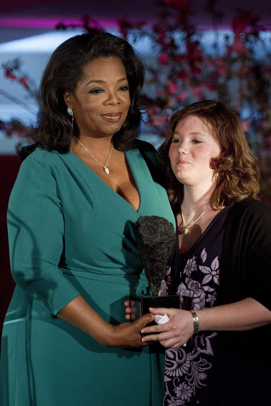 Oprah Winfrey presents Jaycee Dugard with a DVF Award at The Third Annual DVF Awards held at the United Nations in New York, Friday, March 9, 2012. (AP Photo/Charles Sykes)