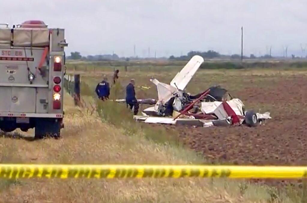 This photo from video provided by KCRA-TV shoes the wreckage of one of two crop dusters that collided in midair and crashed into fields in Yuba City, Calif., Wednesday, May 15, 2019. Both pilots were killed. The Sutter County Sheriff's Office says the single-engine Grumman Ag Cats were seeding the field at the time of Wednesday's collision. (KCRA-TV via AP)