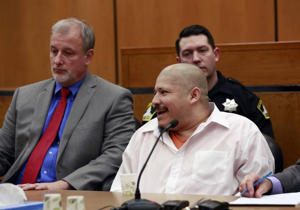FILE - In this Feb. 9, 2018 file photo, Luis Bracamontes smiles at the courtroom audience as the verdict was read in the killing of two law enforcement officers, in Sacramento Superior Court in Sacramento, Calif. Jurors have found a Utah woman guilty of murder for aiding her husband, Bracamontes, as he killed two Northern California sheriff's deputies in 2014. They convicted Janelle Monroy Thursday, Feb. 15, 2018, of 10 charges including murder, attempted murder and carjacking. They rejected her argument that Bracamontes would have killed her if she didn't help him. (AP Photo/Rich Pedroncelli, File)