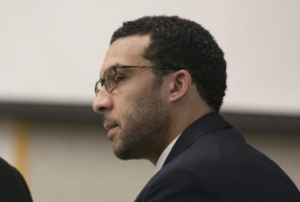 FILE - In this May 20, 2019 file photo Former NFL football player Kellen Winslow Jr. looks at attorney Marc Carlos during his rape trial in Vista, Calif. Prosecutors are expected to announce, Friday, June 14, whether they will retry Winslow Jr. on eight criminal charges left undecided by the jury that convicted the former NFL player of rape. Winslow was convicted Monday of raping a 58-year-old homeless woman and two counts of lewd conduct involving two other women. The jury deadlocked on remaining charges, including two counts of rape involving a hitchhiker and an unconscious teenage girl. (John Gibbins/The San Diego Union-Tribune via AP, Pool,File)