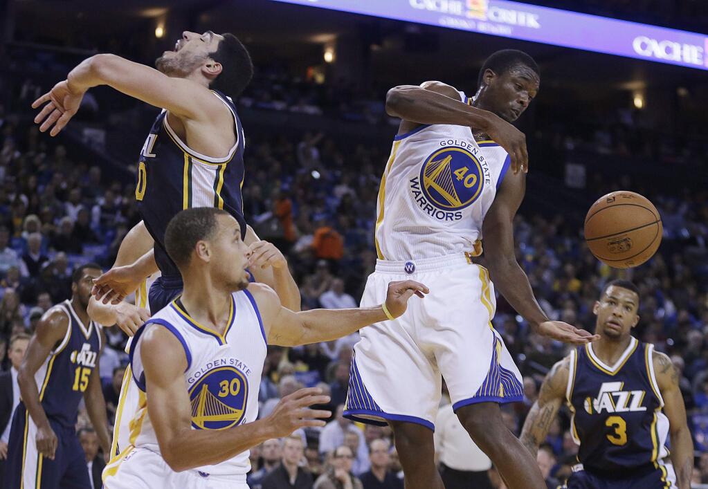 Golden State Warriors' Harrison Barnes (40) reaches for a rebound during the first half of a game against the Utah Jazz on Friday, Nov. 21, 2014, in Oakland. (AP Photo/Ben Margot)