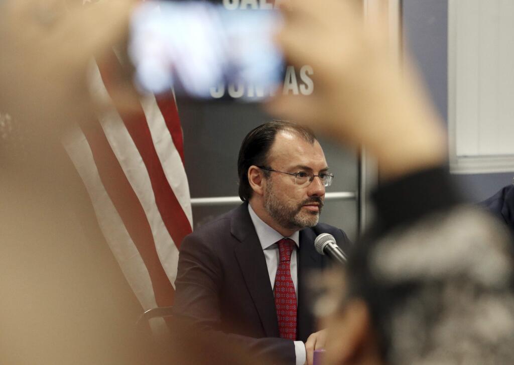 A visitor takes a phone photo of Mexico's Secretary of Foreign Relations Luis Videgaray at the Consulate General of Mexico in Los Angeles Tuesday, Sept. 12, 2017. Videgaray announced support for young immigrants whose protection from deportation is being terminated by Trump. (AP Photo/Reed Saxon)