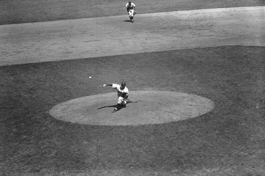 FILE - In this July 5, 1953, file photo, Ralph Branca of the Brooklyn Dodgers pitches against the New York Giants in the 5th inning of a baseball game at the Polo Grounds in New York. Branca, the Brooklyn Dodgers pitcher who gave up the home run dubbed the 'Shot Heard 'Round the World,' has died at the age of 90. His son-in-law Bobby Valentine, a former major league manager, says Branca died Wednesday, Nov. 23, 2016, at a nursing home in Rye, New York. (AP Photo/ Harry Harris, File)