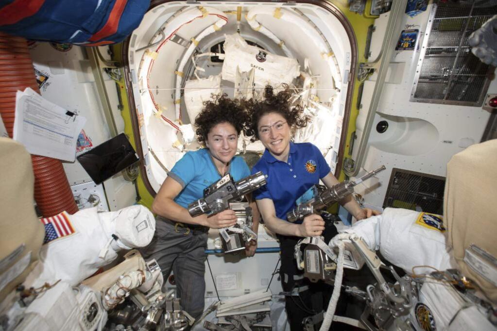 In this photo released by NASA on Thursday, Oct. 17, 2019, U.S. astronauts Jessica Meir, left, and Christina Koch pose for a photo in the International Space Station. On Friday, Oct. 18, 2019, the two are scheduled to perform a spacewalk to replace a broken battery charger. (NASA via AP)