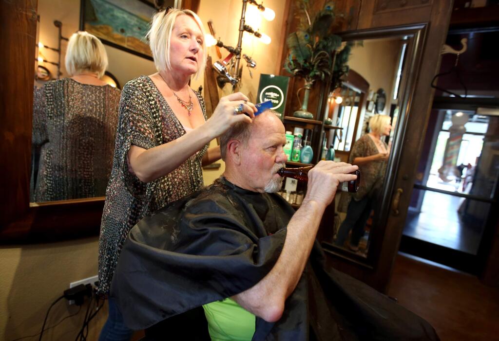 Heather Thorson, owner of The Barbery in Santa Rosa, cuts the hair of regular customer, Gerald Stine, Thursday, April 16, 2015. (CRISTA JEREMIASON / The Press Democrat)
