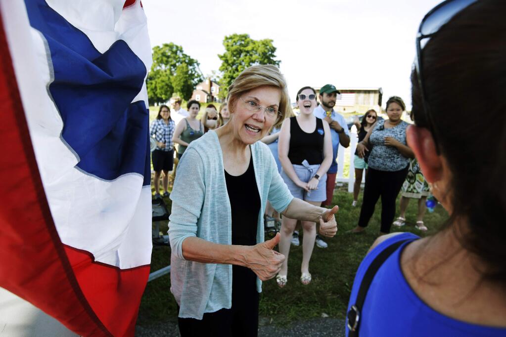 FILE - In this July 8, 2018, file photo, Sen. Elizabeth Warren, D-Mass., greets people following a town hall event at Belkin Family Lookout Farm in Natick, Mass. Sen. Elizabeth Warren is taking the first major step toward running for president. The Massachusetts Democrat said Monday she's launching an exploratory committee for the 2020 campaign. She's the most prominent Democrat yet to make such a move. Warren is one of the most recognizable figures in the Democratic Party and a favorite target of President Donald Trump. (AP Photo/Steven Senne, File)