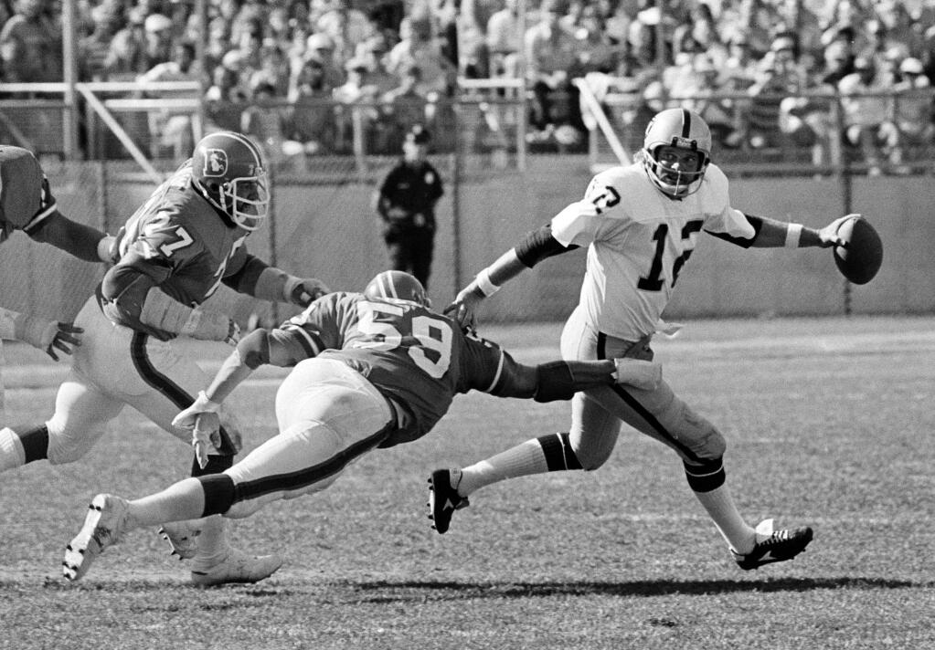 FILE - In this Sept. 4, 1978, file photo, Denver Broncos' Lyle Alzado, left, and Joe Rizzo pursue Oakland Raiders quarterback Kenny Stabler during an NFL football game in Denver.Stabler, who led the Raiders to a Super Bowl victory and was the NFL's Most Valuable Player in 1974, has died as a result of complications from colon cancer. He was 69. His family announced his death on Stabler's Facebook page on Thursday, July 9, 2015. (AP Photo/File)