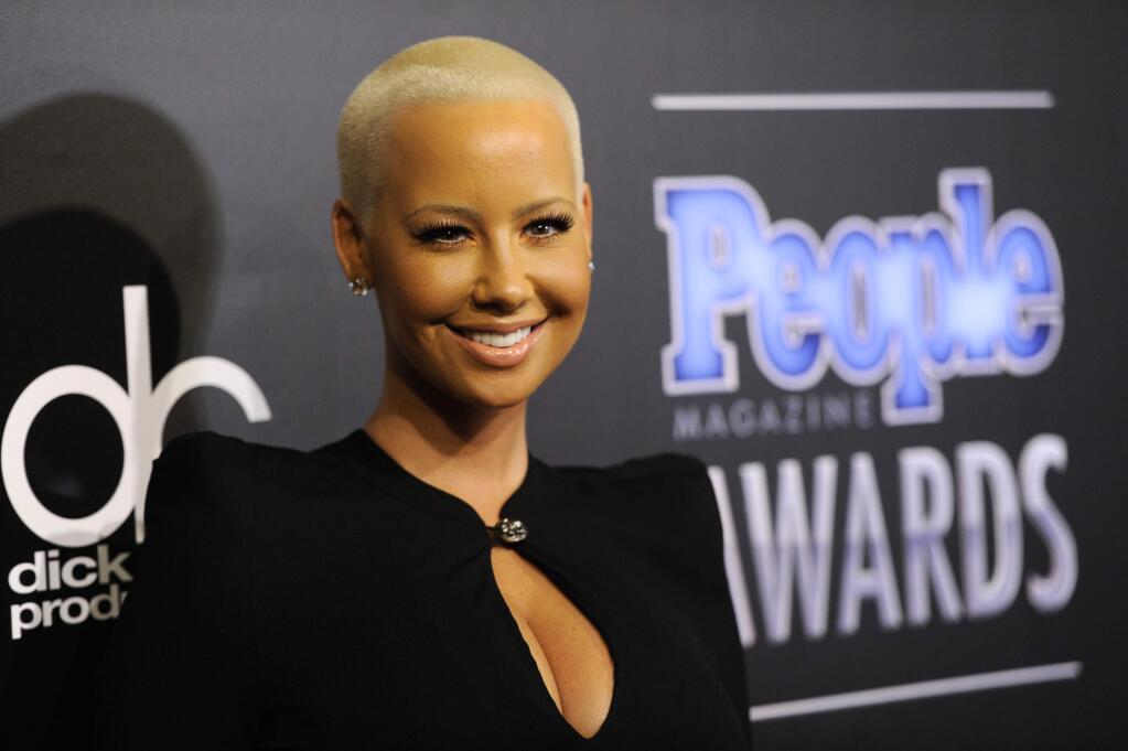 Amber Rose arrives at The People Magazine Awards at the Beverly Hilton hotel on Thursday, Dec. 18, 2014, in Beverly Hills, Calif. (Photo by Chris Pizzello/Invision/AP)