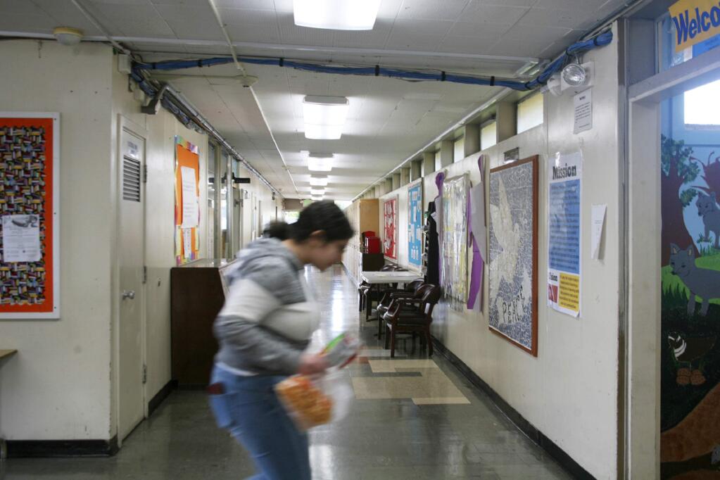 FILE - In this Jan. 27, 2020, file photo, a student walks through a hallway at Lake Elementary School in San Pablo, Calif. California's schools superintendent said Wednesday, May 20, 2020, he expects classes for the state's 6 million students to resume as usual in late August or September. (AP Photo/Jocelyn Gecker, File)