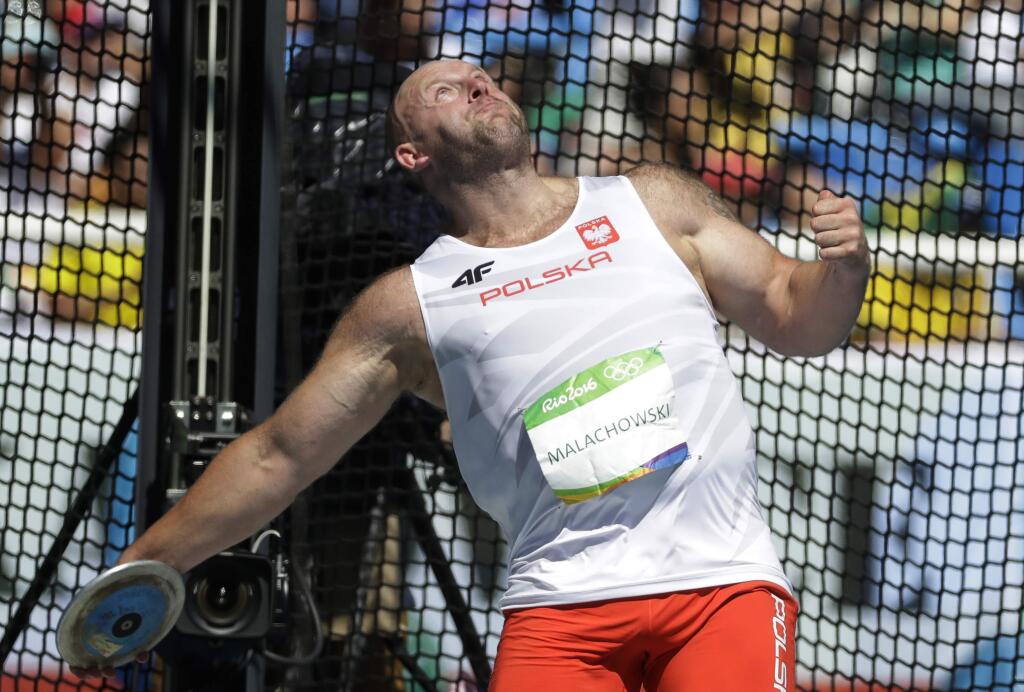Poland's Piotr Malachowski makes an attempt in the men's discus throw final during the athletics competitions of the 2016 Summer Olympics at the Olympic stadium in Rio de Janeiro, Brazil, Saturday, Aug. 13, 2016. (AP Photo/Matt Dunham)