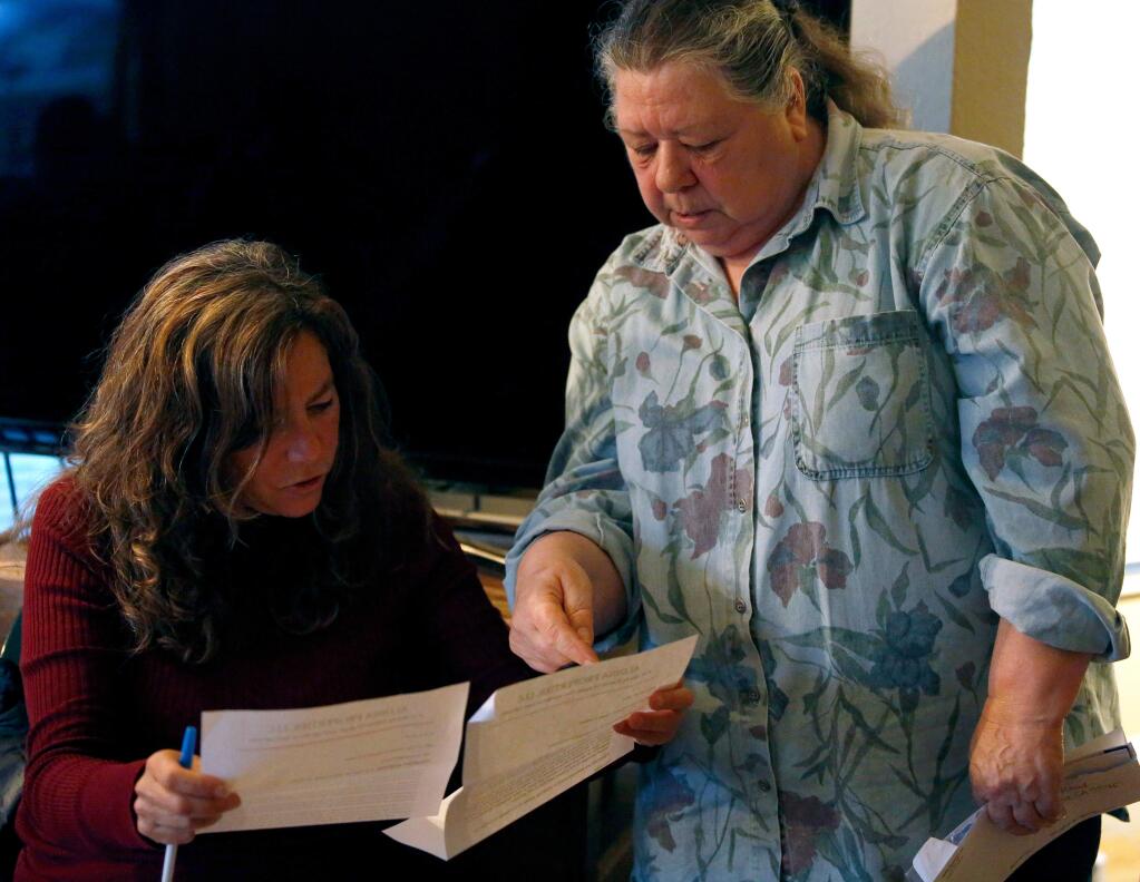 (File photo) Ronit Rubinoff, left, executive director of Legal Aid of Sonoma County looks over letters from the property management company received by evicted tenant Claire Caruso, right, during a meeting between Rubinoff, Supervisor Efren Carrillo and evicted tenants of a block of rental houses off Todd Road in Santa Rosa, California on Thursday, April 14, 2016. (Alvin Jornada / The Press Democrat)