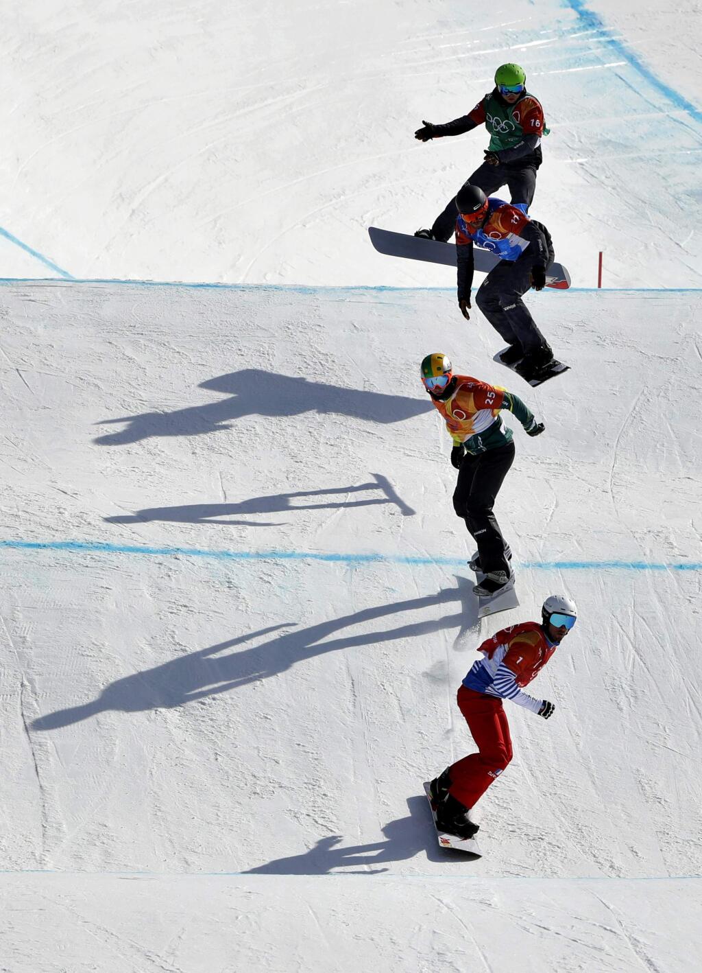 From bottom to top; Pierre Vaultier, of France, Jarryd Hughes, of Australia, Markus Schairer, of Austria, and Hanno Douschan, of Austria, runs the course during the men's snowboard cross elimination round at Phoenix Snow Park at the 2018 Winter Olympics in Pyeongchang, South Korea, Thursday, Feb. 15, 2018. (AP Photo/Gregory Bull)