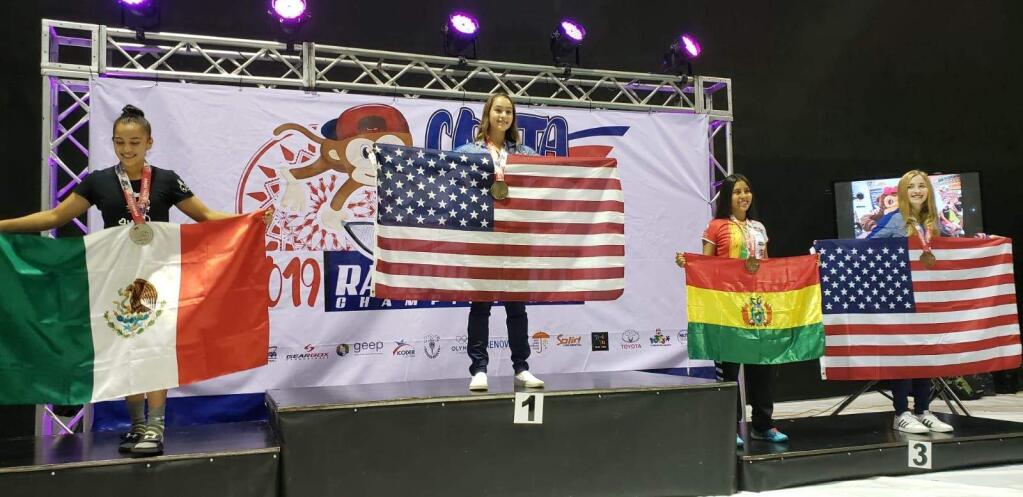 PHOTO BY MELEDESE MAHONEYCasa Grande student Heather Mahoney is center podium after winning the 14 and under singles gold medal at the Junior World Racquetball Championships.