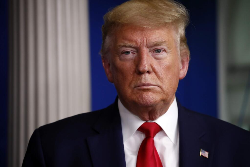 President Donald Trump listens during a briefing about the coronavirus in the James Brady Press Briefing Room of the White House, Friday, April 3, 2020, in Washington. (AP Photo/Alex Brandon)