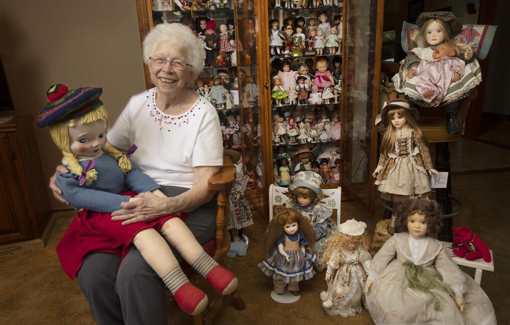 JenniePearl Reese of Healdsburg has collected over 1,000 dolls since she received her first one 82 years ago. On her lap is the French doll her brother sent her when she was 12 years-old, just before he died in battle in World War II in 1944. (photo by John Burgess/The Press Democrat)