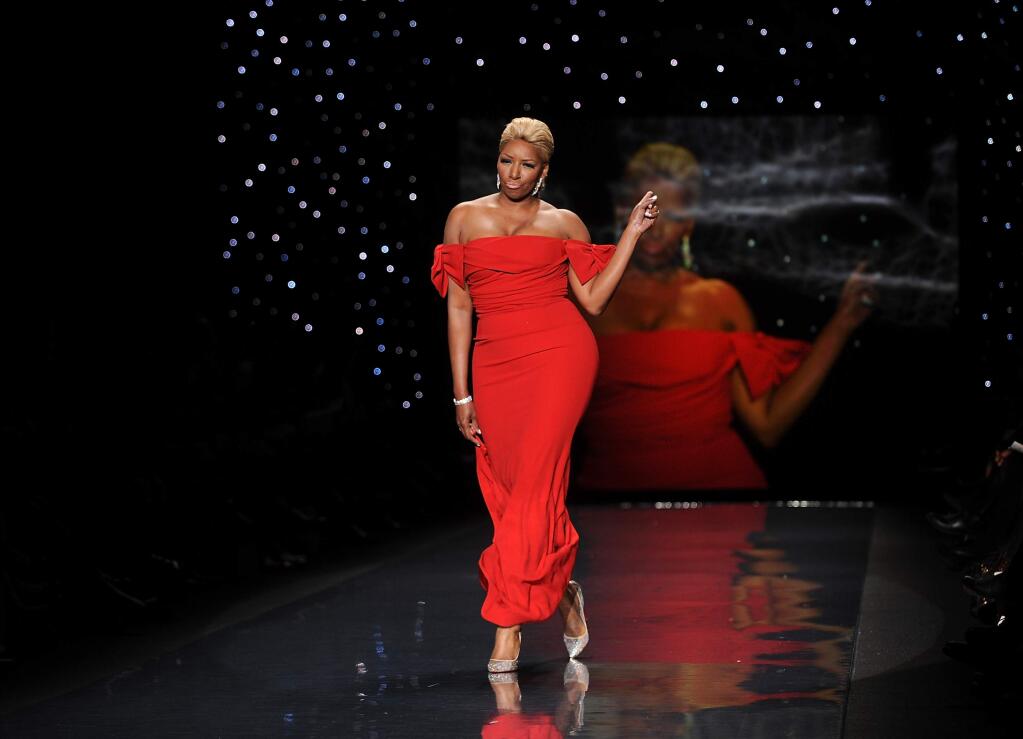 FILE - In this Feb 6, 2014, file photo, actress and TV personality NeNe Leakes models an outfit from the 2014 Red Dress Collection in New York. Leakes announced Monday, June 29, 2015, she is moving on from 'The Real Housewives of Atlanta.' The Bravo channel said that Leakes won't return for the reality show's eighth season this fall. (Photo by Brad Barket/Invision/AP, File)