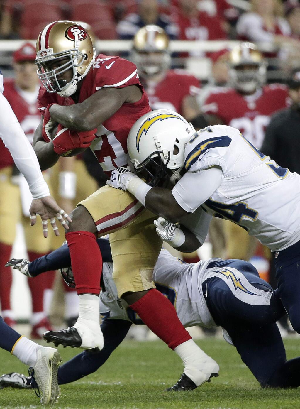 San Francisco 49ers running back Frank Gore (21) runs past San Diego Chargers outside linebacker Melvin Ingram to score on a 52-yard touchdown run during the first quarter of an NFL football game in Santa Clara, Calif., Saturday, Dec. 20, 2014. (AP Photo/Marcio Jose Sanchez)