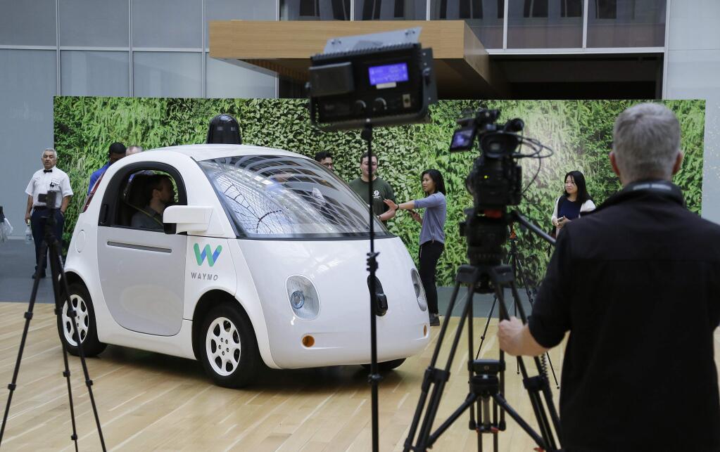 FILE - In this Tuesday, Dec. 13, 2016, file photo, the Waymo driverless car is displayed during a Google event in San Francisco. California regulators have taken an important step to clear the road for everyday people to get self-driving cars. The state's Department of Motor Vehicles on Wednesday, Oct. 11, 2017, published proposed rules that would govern the technology within California, where manufacturers have been testing hundreds of prototypes on roads and highways. (AP Photo/Eric Risberg,File)