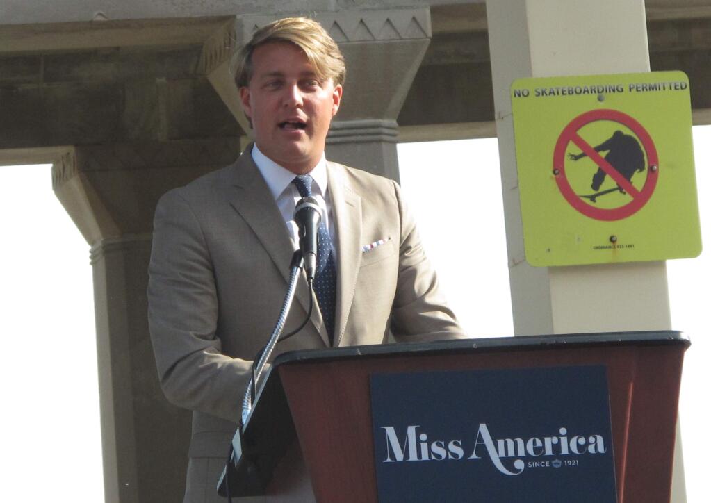FILE- This Aug. 30, 2017, file photo shows Josh Randle, president of the Miss America Organization, speaking at a welcoming ceremony for pageant contestants in Atlantic City N.J. Trashed by emails sent by pageant officials, former Miss Americas will help choose the new leaders of the Miss America Organization. The group told The Associated Press Wednesday, Dec. 27, 2017, that it is enlisting the help of former Miss Americas and state directors to recommend the next generation of leaders for the pageant. The ensuing uproar led to Randle's resignation. (AP Photo/Wayne Parry, File)