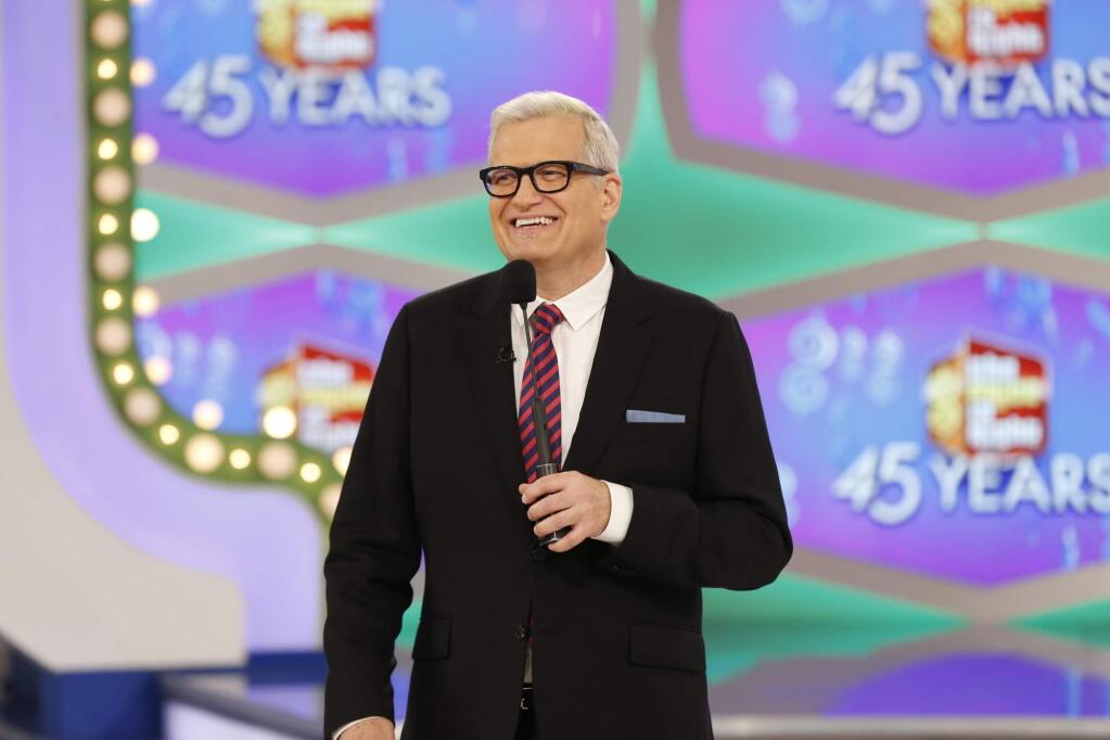 In this image released by CBS, host Drew Carey appears on the set of 'The Price is Right.' On the episode airing Monday, Oct. 17, 2016, a trio of contestants spun $1 on the game show's famous wheel. The three contestants each landed on different combinations of $1 in a pair of spins during one of the show's showcase showdowns. Carey pumped his fist in the air after the contestants achieved the first three-way tie in the show's history. (Monty Brinton/CBS via AP)