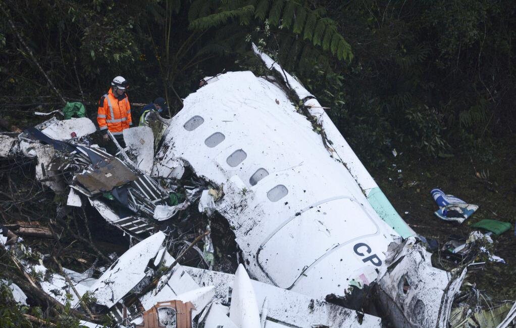 Rescue workers search at the wreckage site of a chartered airplane that crashed outside Medellin, Colombia, Tuesday, Nov. 29, 2016. The plane was carrying the Brazilian first division soccer club Chapecoense team that was on it's way for a Copa Sudamericana final match against Colombia's Atletico Nacional. (AP Photo/Luis Benavides)