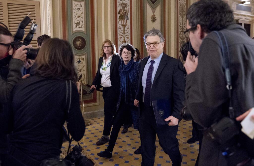 Sen. Al Franken, D-Minn., arrives with his wife Franni Bryson, center left, on Capitol Hill in Washington, Thursday morning, Dec. 7, 2017. Franken said he will resign from the Senate in coming weeks following a wave of sexual misconduct allegations and a collapse of support from his Democratic colleagues, a swift political fall for a once-rising Democratic star. (AP Photo/Andrew Harnik)
