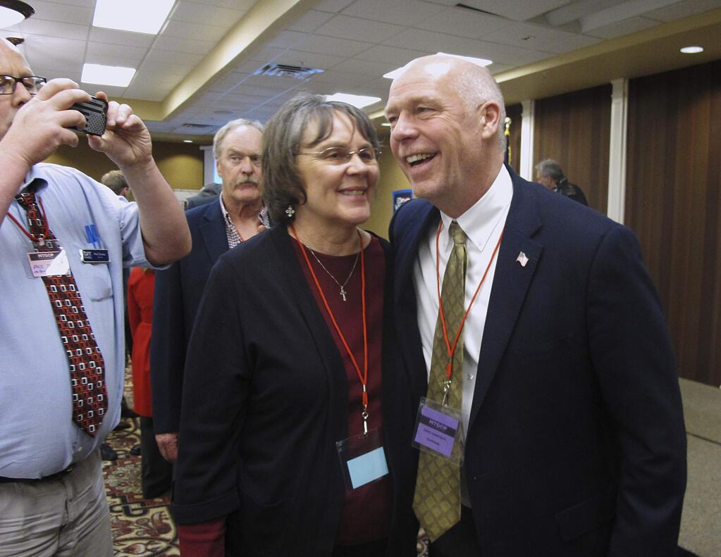 FILE - In this March 6, 2017, file photo, Greg Gianforte, right, receives congratulations from a supporter in Helena, Mont. Montana voters are heading to the polls Thursday, May 25, 2017, to decide a nationally watched congressional election amid uncertainty in Washington over President Donald Trump's agenda and his handling of the country's affairs. (AP Photo/Matt Volz, File)