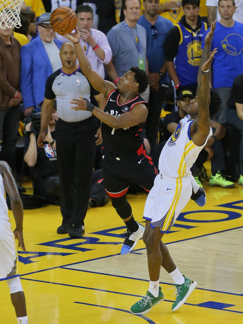 Toronto Raptors guard Kyle Lowry lays the ball in past Golden State Warriors forward Jordan Bell during game 3 of the NBA Finals in Oakland on Wednesday, June 5, 2019. (Christopher Chung/ The Press Democrat)