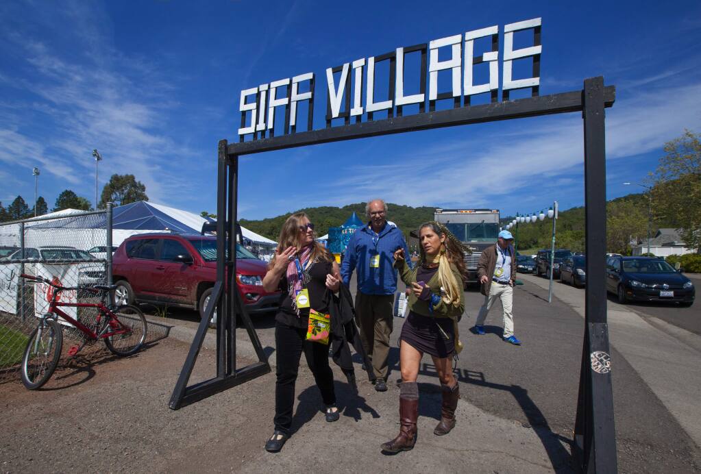 Robbi Pengelly/Index-TribuneTeitzan Karys, Will Ackley and Janet Doerge leave SIFF Village on Saturday to take in a film at the Sebastiani Theatre.