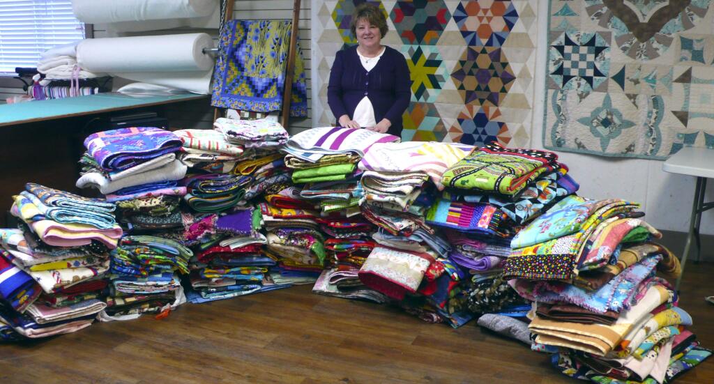 Submitted photoBroadway Quilts owner Gery Rosemurgy with 260 of the 863 quilts that were donated for te children in Middletown.