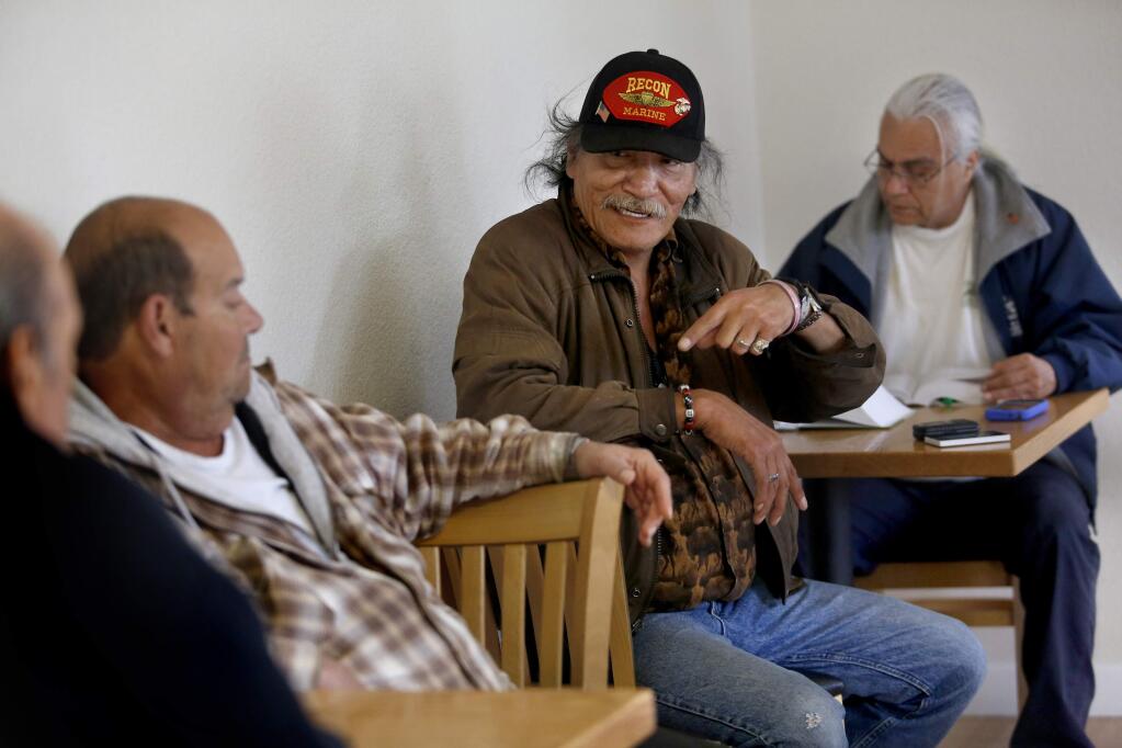 Eagle Lone Fight talks with other veterans, Bobbie Victorino, left, and Rudy Berain, right, at the Hearn Avenue Veterans Housing in Santa Rosa on Monday, April 6, 2015. (BETH SCHLANKER/ PD)