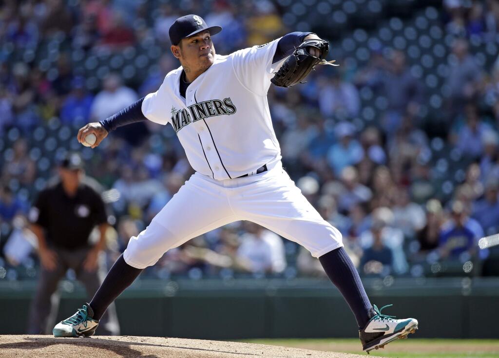 Seattle Mariners starter Felix Hernandez throws his first pitch of the game, which resulted in a home run for Oakland Athletics' Billy Burns, in the first inning of a baseball game Wednesday, Aug. 26, 2015, in Seattle. (AP Photo/Elaine Thompson)