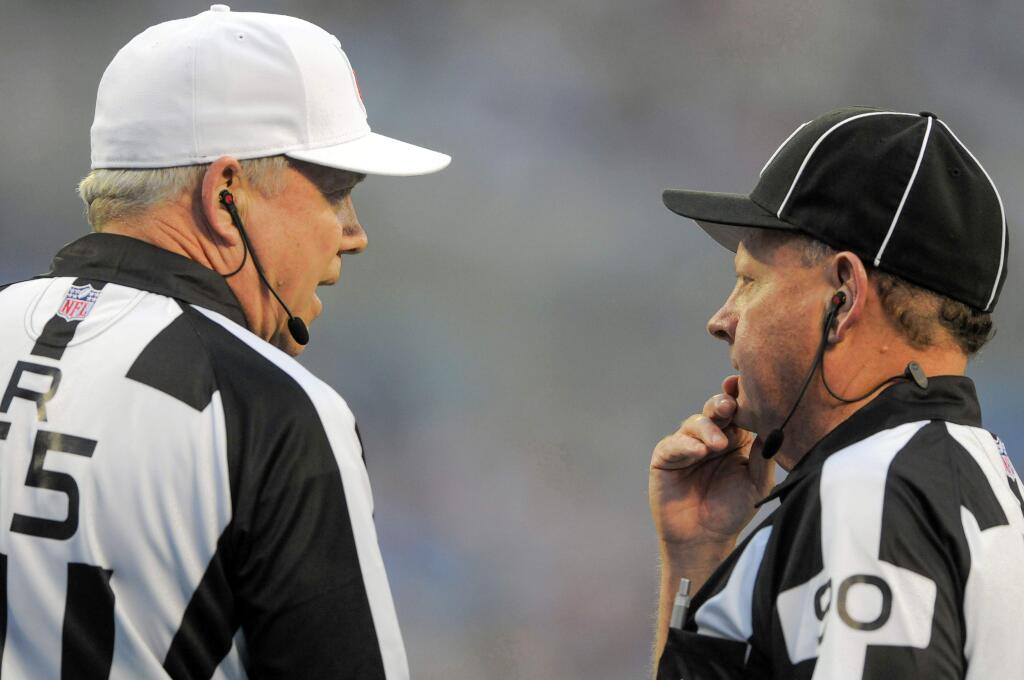 Referee Walt Coleman, left ,talks with line judge Mike Spanier during a preseason NFL football game Friday. (Associated Press / Mike McCarn)