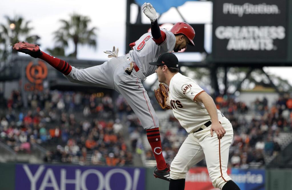 San Francisco Giants pitcher Ty Blach, right, tags the Cincinnati Reds' Billy Hamilton along the first base line after a ground ball during the first inning Thursday, May 11, 2017, in San Francisco. (AP Photo/Marcio Jose Sanchez)