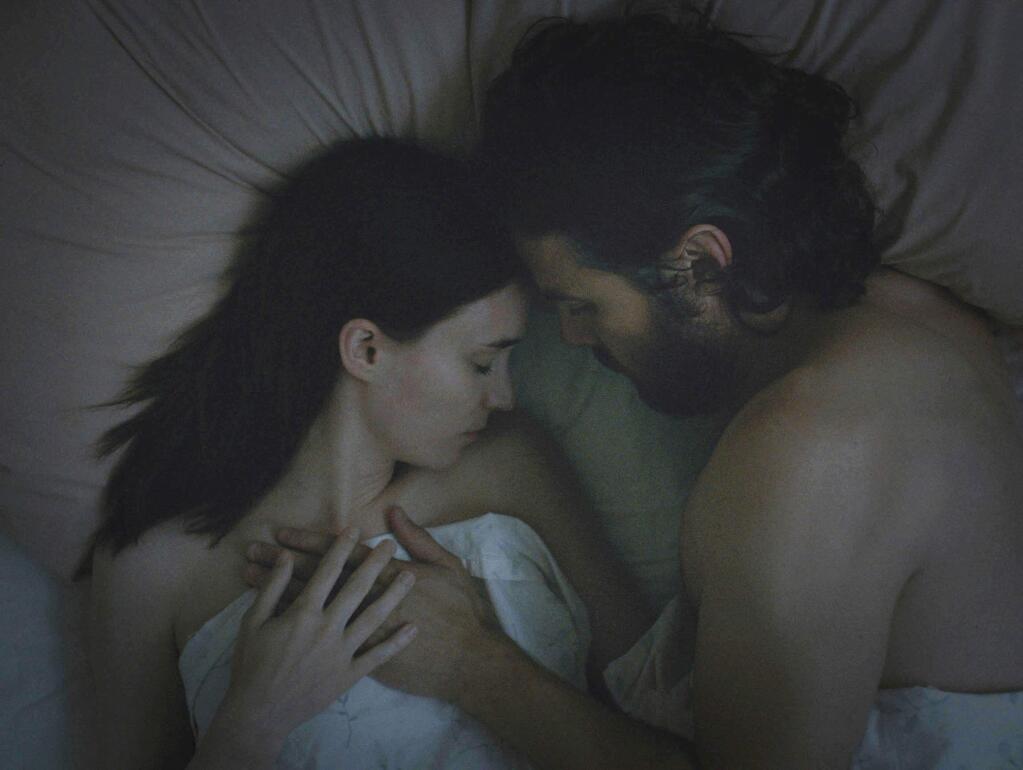 This image released by the Sundance Institute shows Rooney Mara, left, and Casey Affleck in a scene from 'A Ghost Story,' by filmmaker David Lowery, an official selection of the NEXT program at the 2017 Sundance Film Festival. The film reunites co-stars Mara and Affleck, who starred as outlaw lovers in “Ain't Them Bodies Saints.' (Andrew Droz Palermo/Sundance Institute via AP)