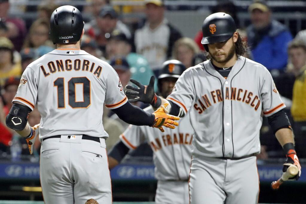 The San Francisco Giants' Evan Longoria (10) is greeted by Brandon Crawford after hitting a solo home run off Pittsburgh Pirates starting pitcher Chad Kuhl during the second inning in Pittsburgh, Saturday, May 12, 2018. (AP Photo/Gene J. Puskar)