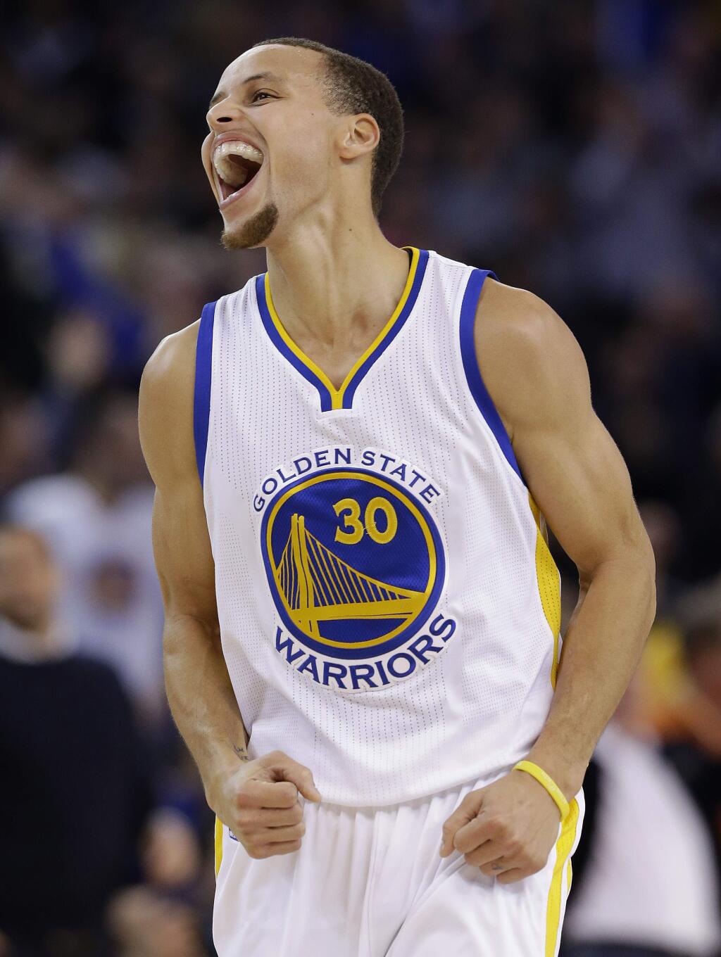 Golden State Warriors guard Stephen Curry (30) celebrates after scoring against the Houston Rockets during the first half of an NBA basketball game in Oakland, Wednesday, Jan. 21, 2015. (AP Photo/Jeff Chiu)
