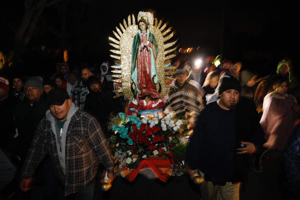 Members of Our Lady of Guadalupe Catholic Church carry a figure of Mary as the procession for Feast Day of Our Lady of Guadalupe makes its way along Old Redwood Highway in Windsor on Wednesday, Dec. 12, 2018. (BETH SCHLANKER/ PD)