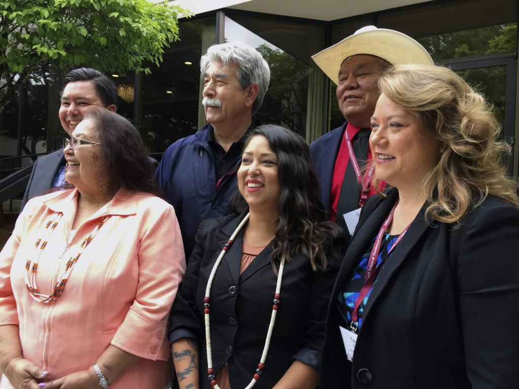 Tribal leaders from the Pacific Northwest pose for a picture during a meeting of the Members of the Affiliated Tribes of Northwest Indians in Portland, Ore., Thursday, May 25, 2017. The group held a news conference during their annual convention to criticize cuts to Native American programs in President Donald Trump's proposed budget that they say will devastate tribes across the U.S. Front row, from left, are Cheryl Kennedy, vice chairwoman of the Confederated Tribes of the Grand Ronde; Carina Miller, councilwoman with the Confederated Tribes of Warm Springs; and Fawn Sharp, president of the Affiliated Tribes of Northwest Indians. Back row, from left, are Timothy Ballew, member of the Lummi Nation; Mel Sheldon, councilman with the Tulalip Tribes and Gary Burke, chairman of the board of trustees for the Confederated Tribes of the Umatilla Indian Reservation. (AP Photo/Gillian Flaccus)