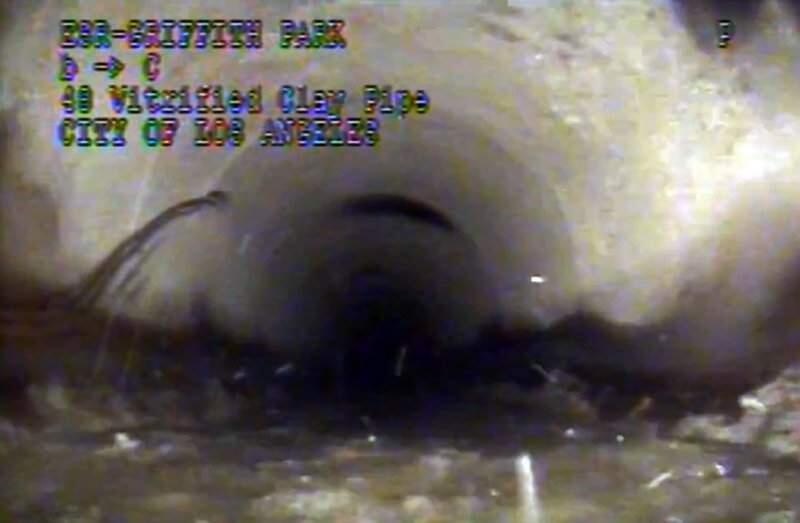 This photo from remote camera video provided by the Los Angeles Department of Sanitation shows where 13-year-old Jesse Hernandez traced an arc with his fingers, at left, as he was swept through a 4-foot diameter sewer pipe after falling into a hole in Griffith Park in Los Angeles, Monday, April 2, 2018. Hernandez spent more than 12 hours in the toxic environment of the sewer system before being rescued. (Los Angeles Department of Sanitation via AP)