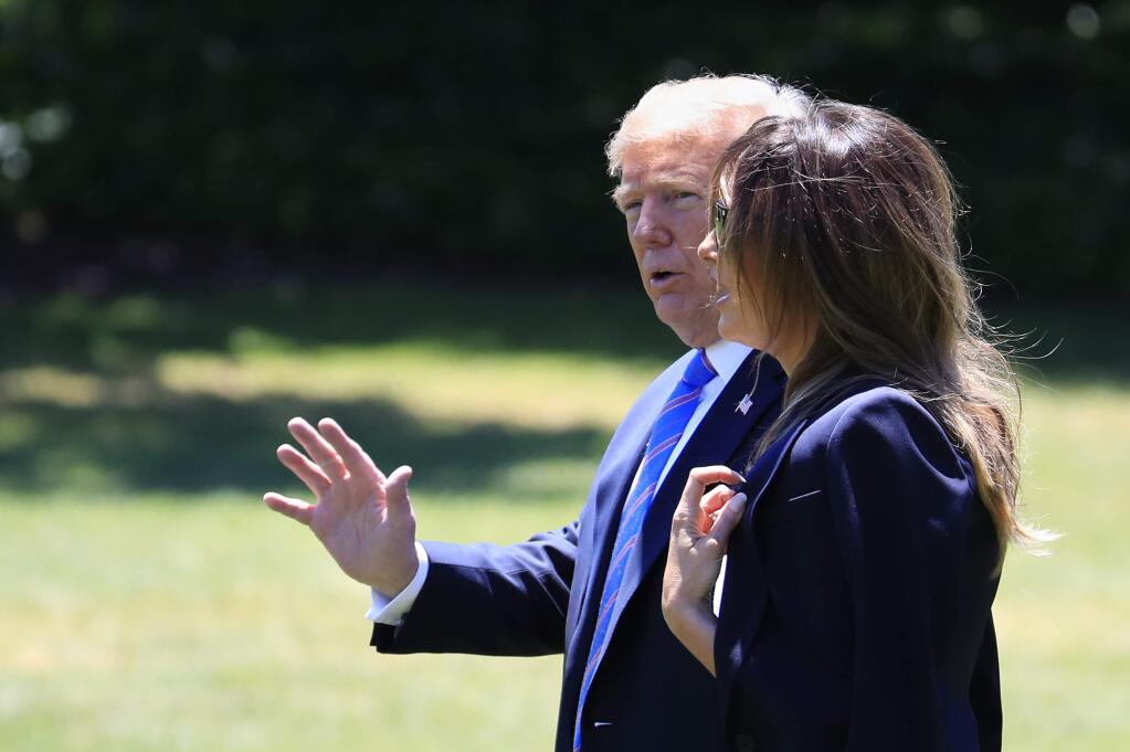 President Donald Trump walks with first lady Melania Trump, waves as they leave the White House in Washington, Wednesday, July 18, 2018, as they travel to Andrews Air Force Base to pay their respects to the family of fallen U.S. Secret Service special agent Nole Edward Remagen who suffered a stroke while on duty in Scotland. (AP Photo/Manuel Balce Ceneta)