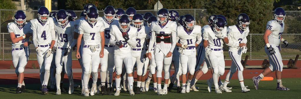 SUMNER FOWLER/FOR THE ARGUS-COURIERPetaluma's Trojans prepare to run onto the field for the first time this season.