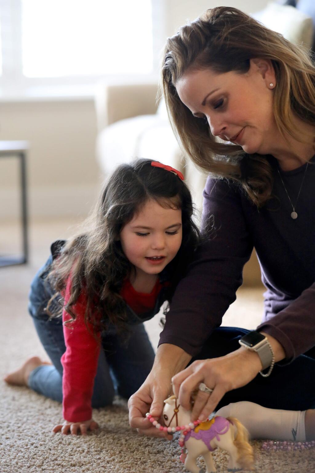 Keri Vellis plays with her adopted daughter Sara, 4, at their home in Santa Rosa on Sunday, Jan. 12, 2020. (BETH SCHLANKER/ The Press Democrat)